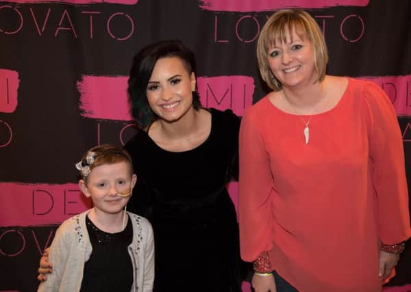 Cancer sufferer Ashlee Easton from Brightons with mum Lisa and singer Demi Lovato at the Hydro in Glasgow