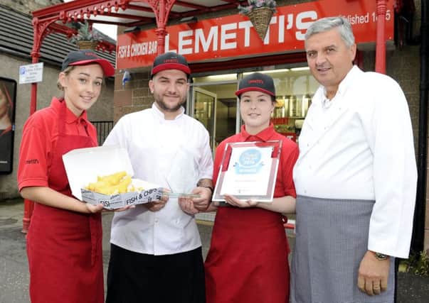 (L-R) Worker Cara Black, licensee Djlan Vettraino, manager Hannah Ironside and shop owner Gino Notarangelo with their prize and a fish supper. Picture: Michael Gillen