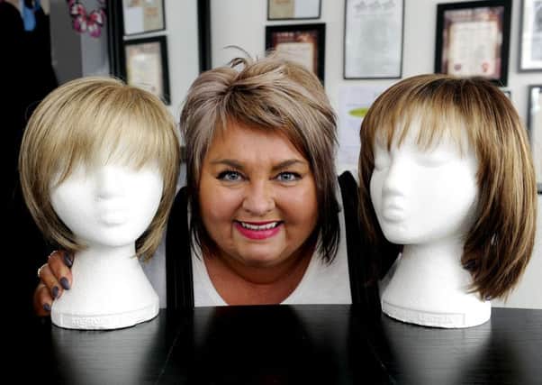 Jill Lauder with the wigs she fits during Feel Good days