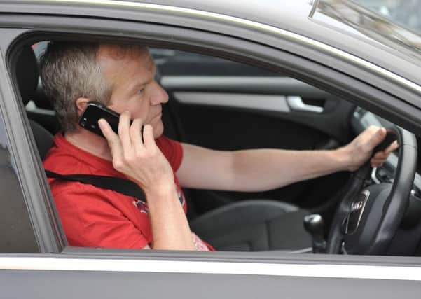 Fewer motorists have been caught on their mobile phone. Posed by a model
