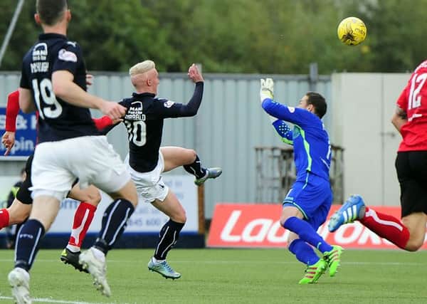 Falkirk's Craig Sibbald lobs in a brilliant opening goal against Dunfermline (Pic by Michael Gillen)