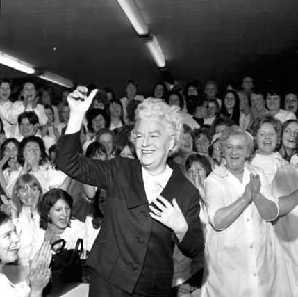 Veteran singer and actress Gracie Fields waves goodbye to the workers  after her visit