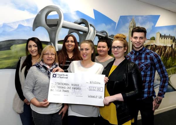Nicole, centre, with colleagues from Webhelp who rallied round to raise money for Strathcarron. Picture: Michael Gillen