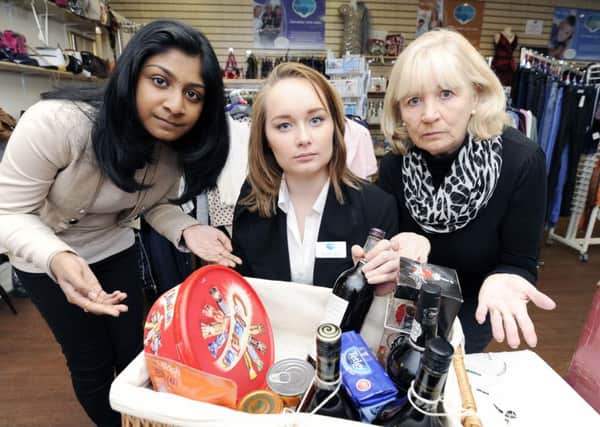 Disgusted - (left to right)  volunteer Annette Selwyn, Retail Supervisor Jennifer Smith and volunteer Sarah Polson are horrified at the heartless theft from the shop's Christmas hamper.