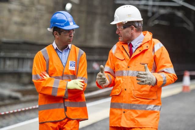 Transport Minister Humza Yousaf, left, with ScotRail Alliance managing director Phil Verster  during the works at Glasgow's Queen Street station. Picture: John Devlin