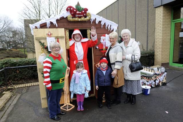 Santa's Grotto opened today (Friday) in Camelon as part of the Winter Festival. Among the first to meet him and his elf helper were  Rebecca (4) from Bonnybridge, Maison (3) from Camelon, child minder Jacqueline Howe and her mum Joan McBride
Picture: Michael Gillen