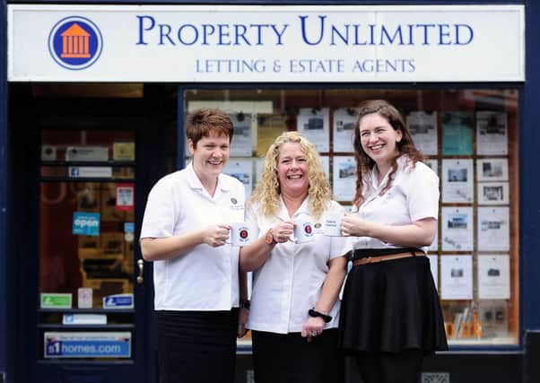 Pauline, Kristene and Jay toast the continued success of Property Unlimited