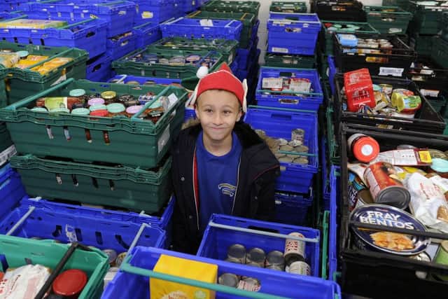 Callum loved working at the foodbank helping others this week. Picture: Michael Gillen