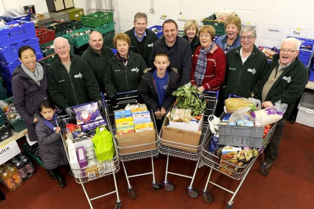 Volunteers, staff and Callum with the food collected by Falkirk Herald staff during our foodbank day last week. Picture: Michael Gillen