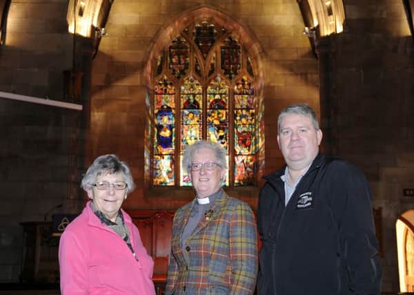 Church elder Julia Marshall, Minister Alison Meikle and elder Dale Lyon at the window. Picture: Michael Gillen