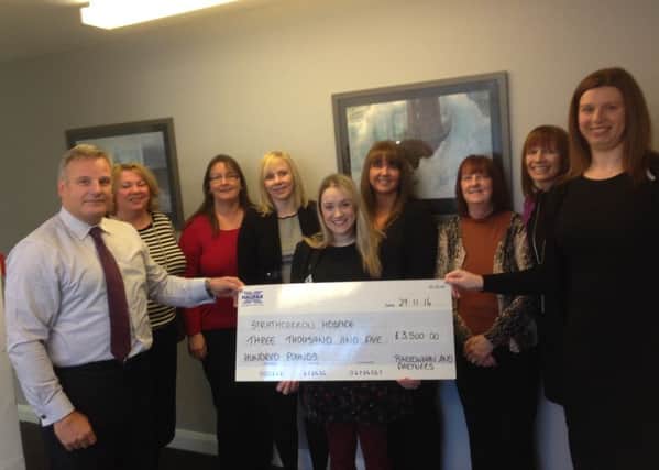 Barrowman and Partners hand over funds to Strathcarron for its Gift in Wills campaign.