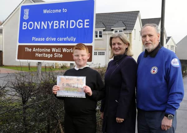 Andrew joins Councillor Gow and Mr McGregor beside the new sign
