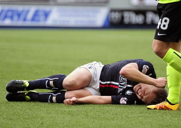 Peter Grant was in obvious pain after his tackle. Pic by Michael Gillen