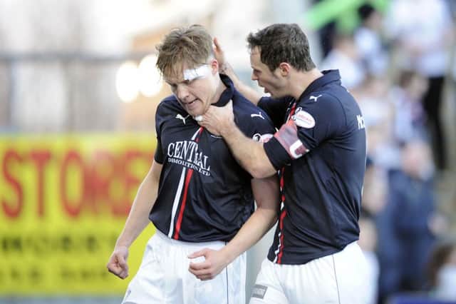 Peter Grant celebrates with defensive partner David McCracken. Pic by Michael Gillen.