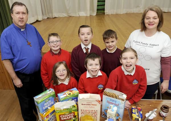 Rev. David Smith and volunteer co-ordinator Margaret-Anne Milne at the breakfast club with some of the kids. Picture: Michael Gillen
