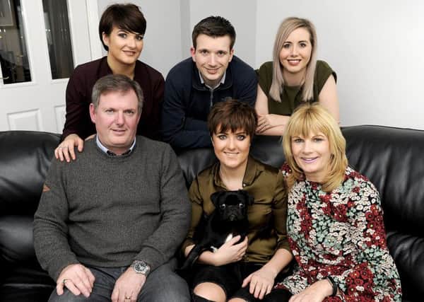 Mandie Stevenson and pug Frank surrounded by her family  dad John, mum Pauline, sister Nicola, twin brother Gary and sister-in-law Laura, back right. Picture: Michael Gillen