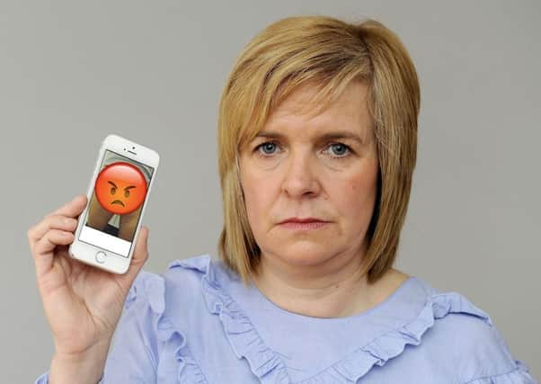 Lynn Conlin with her iPhone and the offending image. Picture: Michael Gillen