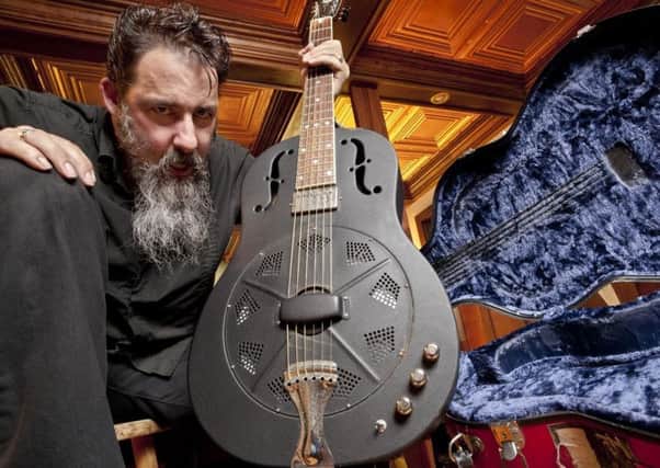 Hairy bluesman in black Dave Arcari will be thrashing his guitar this week