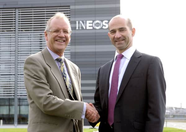 Ineos chief executive officer John McNally shakes hands on the Â£200 million deal with Peter Miller, vice president of Midstream BP North Sea