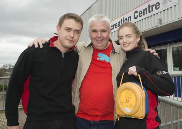 Kevin McKay, centre, with life-savers Mikey Christie and Ruth Prophet. Picture: Craig Halkett