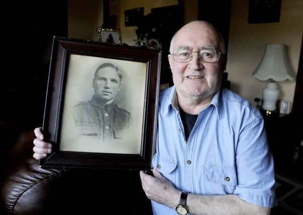 Michael with a picture of his grandfather who went to war Michael Sylvester McMahon