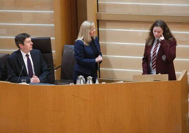 Jemma speaks in sign language at the Scottish Parliament
