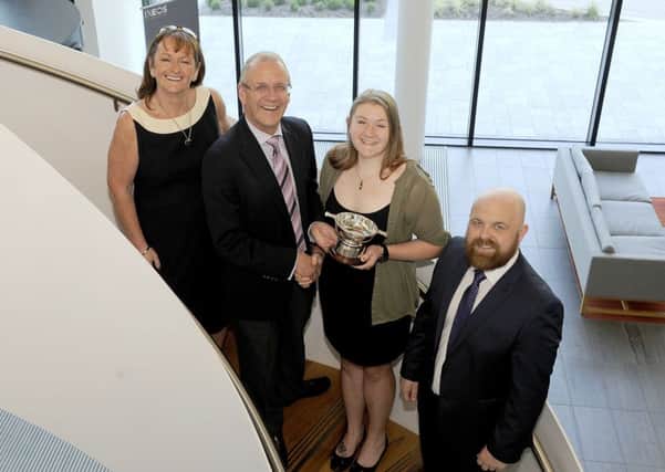Megan McWatt receives her award from Ineos CEO John McNally as Jane Hall and Chris Hall look on