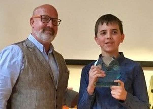 Aidan Wansbrough (13) receives his prize from crime author  Michael J Malone