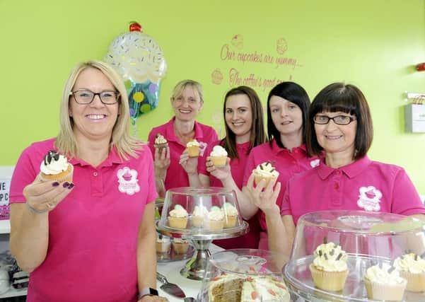 Angela Gallagher, left, and the talented and dedicated team at Cupcake Corner take time out to enjoy their own creations. Picture: Michael Gillen