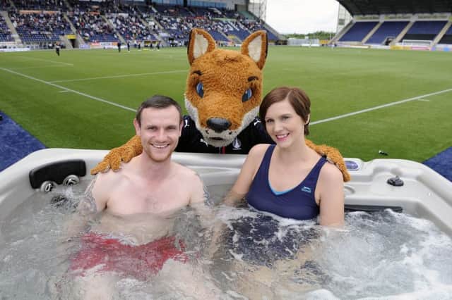 Jamie Gow 34 and Nikki Gow 34, won the chance to watch Falkirk v Dumbarton from a pitchside hot-tub. Picture by Michael Gillen.