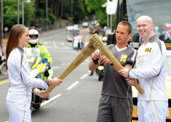 Robert Marshall, right, was chosen as an Olympic torch bearer due to the way he battled cancer. Picture: Michael Gillen