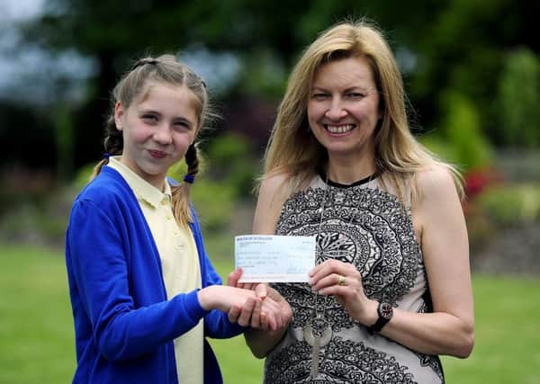 Limerigg primary pupil Niamh McGregor with Strathcarron Hospice community fundraiser Marion Blaney. Picture: Michael Gillen