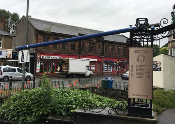 Vandals shoved the bus stop sign through the railings of the memorial in Bonnybridge