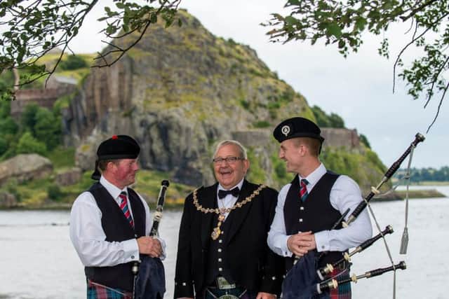 Games Chieftain Provost William Hendrie chats to pipers Alan Lochore and Douglas Murray.