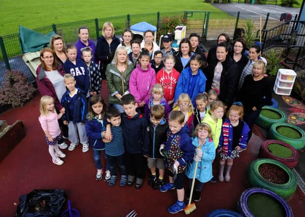 Parents and children turn out to clear up after vandalism at Carron Primary School. Picture: Michael Gillen