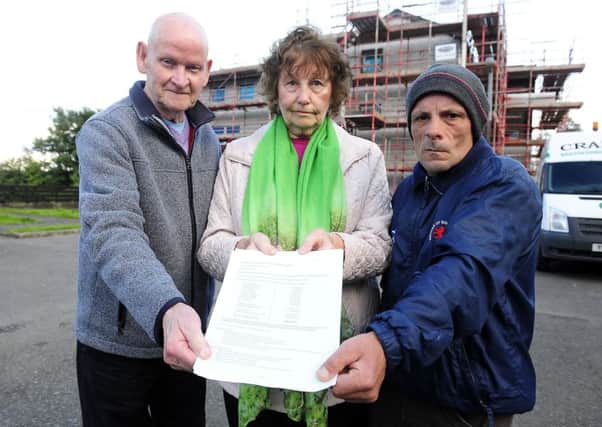 Ex-council house owners James and Morag Tulloch and John Jackson with one of the bills. Picture: Michael Gillen