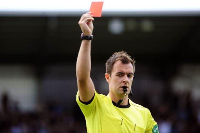 Don Robertson showed the defender the red card, after sending off two of the backroom staff in the first half.