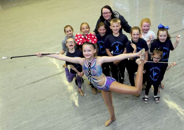 Kaitlin Lawrence, front, with her twirling pals at Forth Valley Baton Twirlers and coach Yvonne Brown. Picture: Michael Gillen