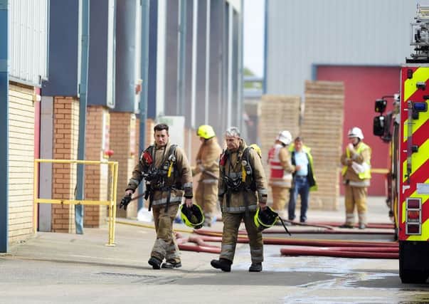 Fire fighters at the scene earlier this afternoon. Picture: Michael Gillen