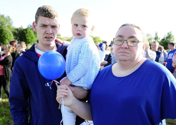 Russell Robertson's brother, Steven, nephew Preston Robertson and mum Margaret at a balloon release in his memory. Picture: Michael Gillen