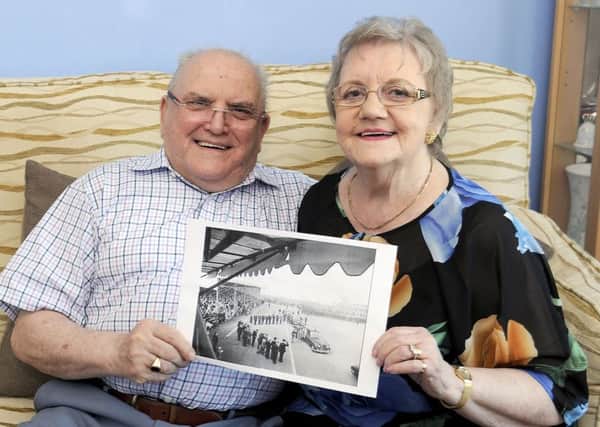 Margaret and George Huskie with their wedding photo and picture of the Queensferry Crossing taken exactly 53 years later