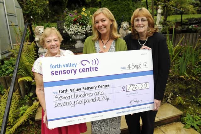 G reen fingered Malvina presents the cheque