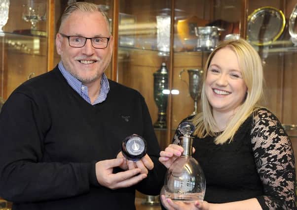 Alastair Brookes, business development director at Citrus Office Solutions and Claire MacDonald, business development fundraiserat  Strathcarron Hospice, show off the limited edition glassware.