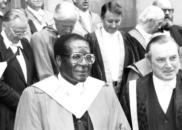 Zimbabwe Prime Minister Robert Mugabe receives his honorary degree from the University of Edinburgh at McEwan Hall in July 1984. To Mr Mugabe's right in picture is Principal Dr John Burnett and behind the Principal, David Steel.