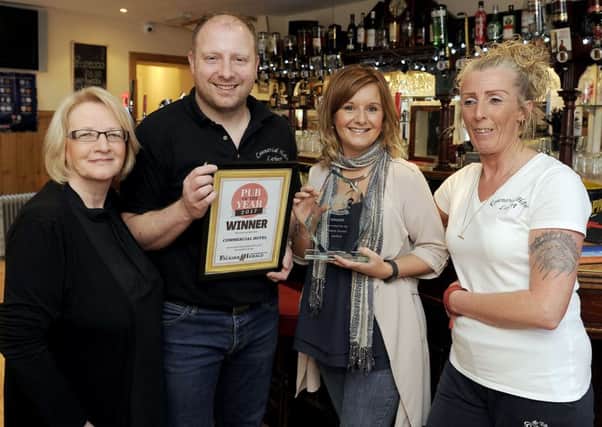 Pictured with the Falkirk Herald trophy are, from left, Anne Burden, bar staff; Mark Barnett, owner; Gemma Barnett, owner and Joanne Scott, bar staff.