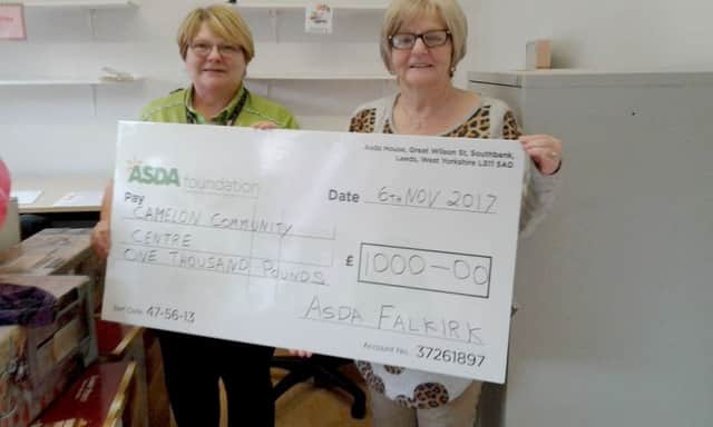 Asda community champ Margaret Bradie presents a Â£1000 cheque to Ann Henderson on behalf of Camelon Community Centre.
