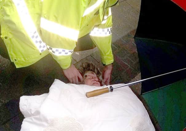 Police help Mary-Ann Cook (70), who tripped and fell in La Porte Precinct, Grangemouth. She was forced to wait over two hours for an ambulance due to the high level of calls the Scottish Ambulance Service was experiencing at the time