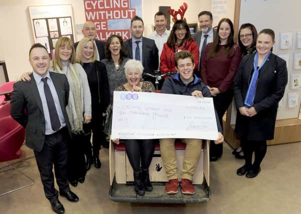 Carol Anderson, TSB business and branch distribution director Scotland, presents Fraser Johnson with the Â£10,000 cheque for Cycling Without Age. Pic: Michael Gillen