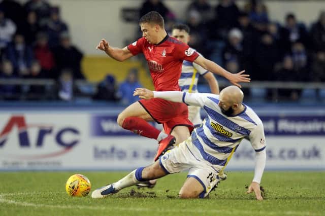 Andrew Nelson was in the thick of it at Cappielow, and leapt over this Gary Harkins challenge. Picture Michael Gillen.
