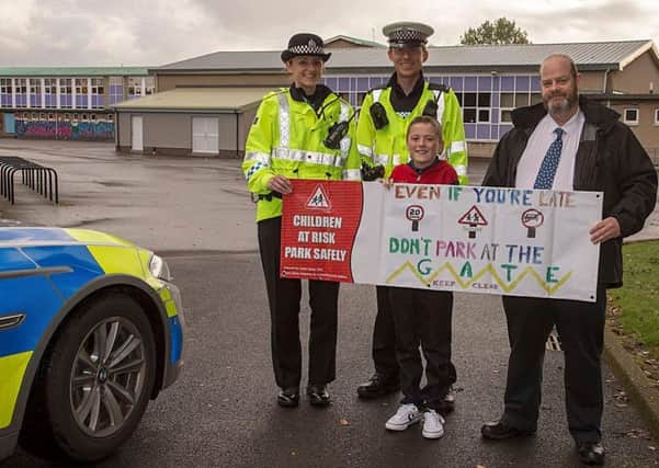 Forth Valley police, councillor David Balfour and road safety poster design winner Adam Keltie asked drivers not to park near school gates